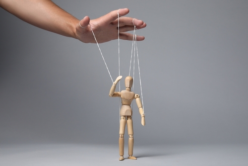 Man,Pulling,Strings,Of,Puppet,On,Gray,Background,,Closeup