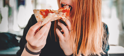 Woman,Hand,Takes,A,Slice,Of,Meat,Pizza.,Young,Woman