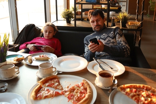 Dad,And,Daughter,Are,On,Their,Phones,In,A,Cafe