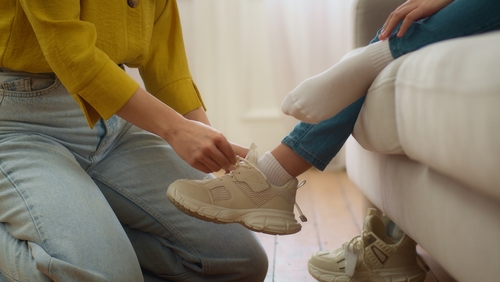 Unrecognizable,Loving,Caucasian,Woman,Mother,Carer,Female,Hands,Lacing,Ties