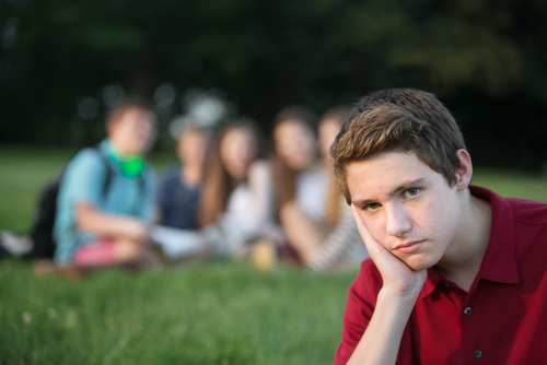 Lonely,Male,Teenager,Sitting,With,Hand,On,Cheek